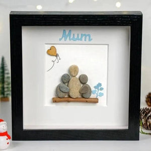 Handmade Pebble Art Children Embracing Mother Inside a Snowy Floral Scene by Dovaart.com