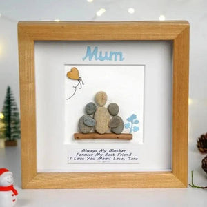 Handmade Pebble Art Children Embracing Mother Inside a Snowy Floral Scene by Dovaart.com