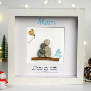 Handmade Pebble Art Children Embracing Mother Inside a Snowy Floral Scene by Dovaart.com